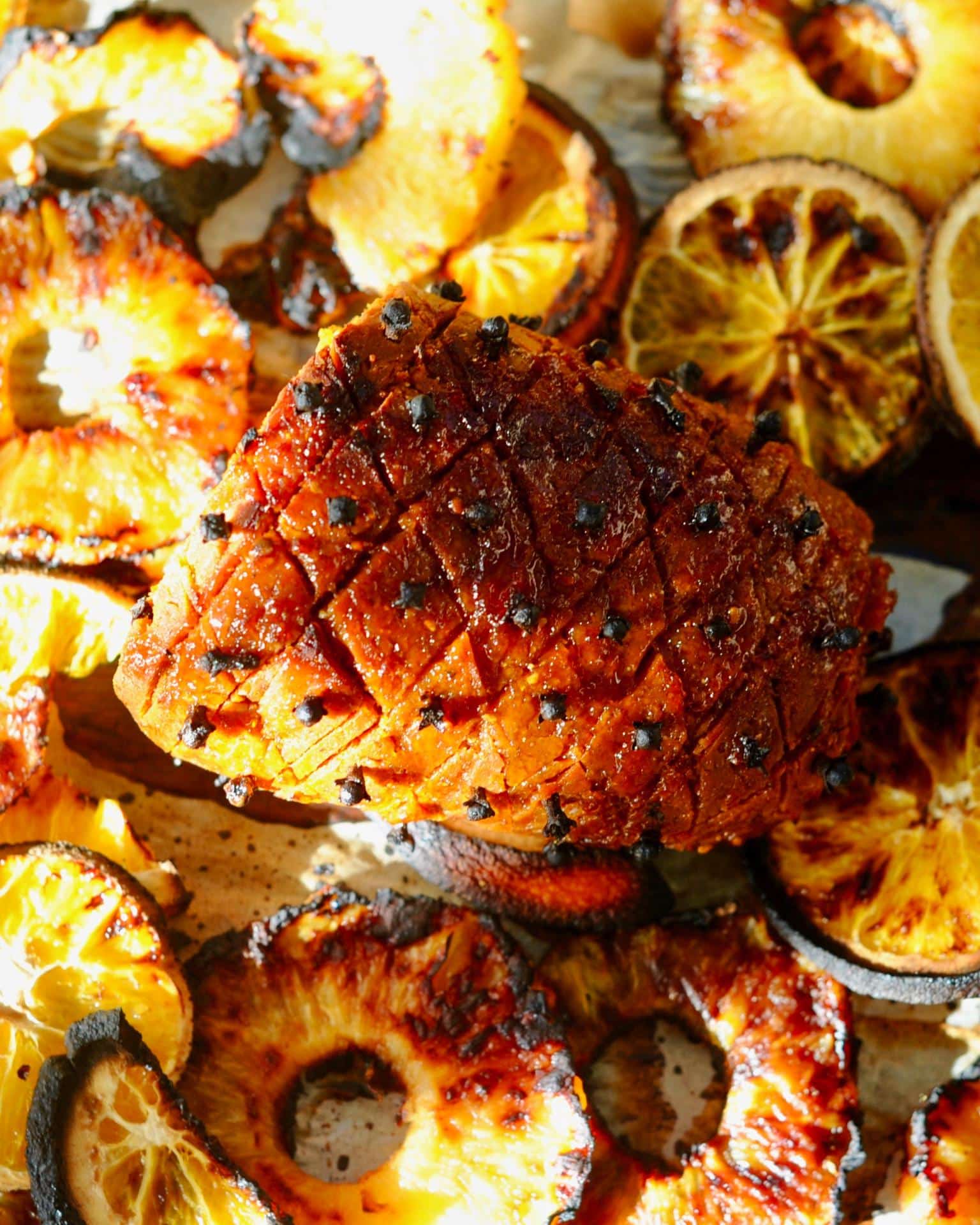 Maple glazed vegan holiday ham with fruit and cloves