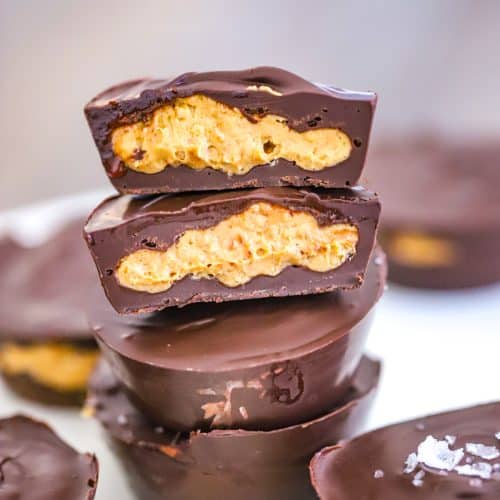 Chocolate peanut butter cups stacked on top of each other.