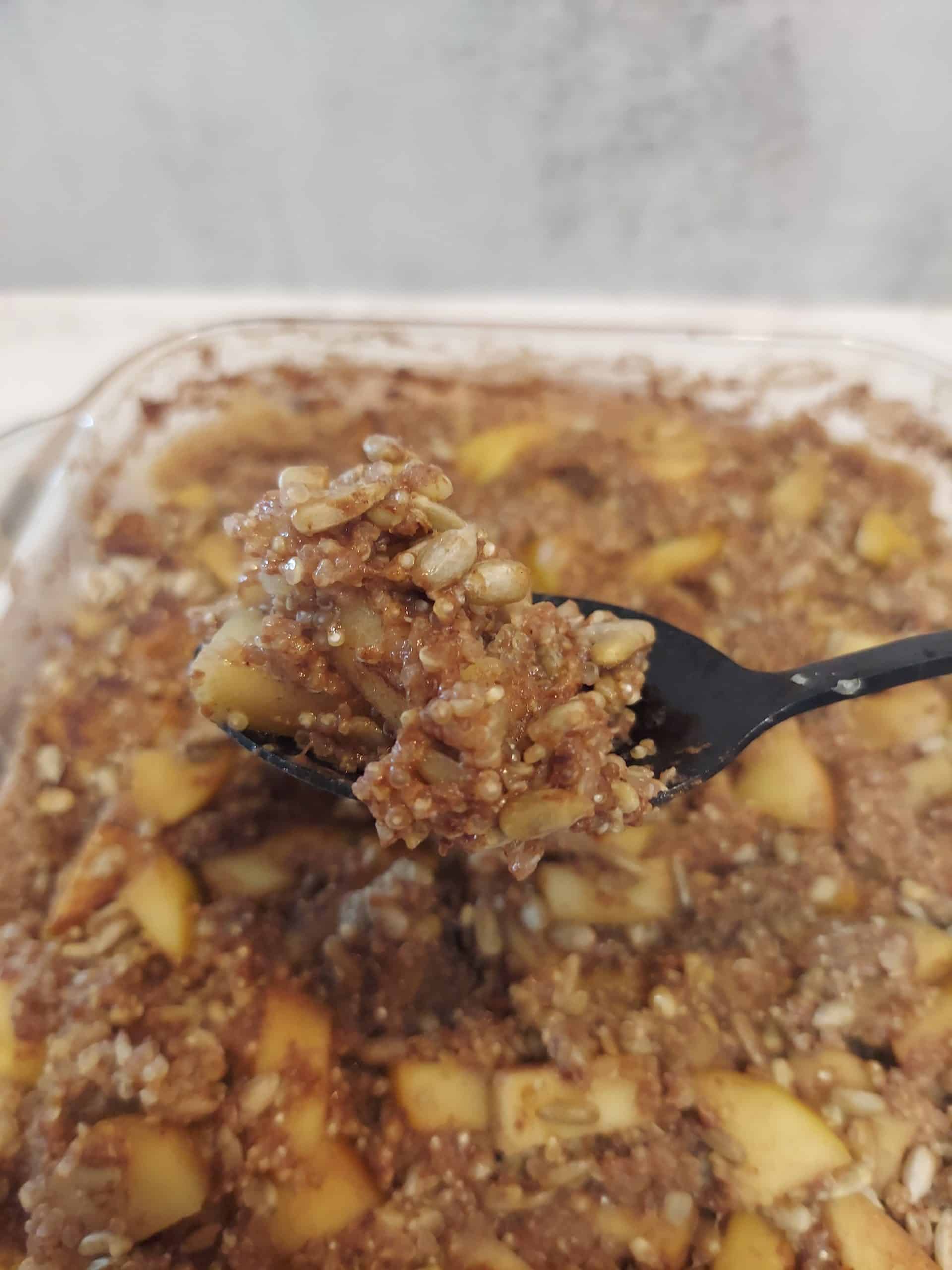 spoonful of apple cinnamon quinoa bake showing creamy texture