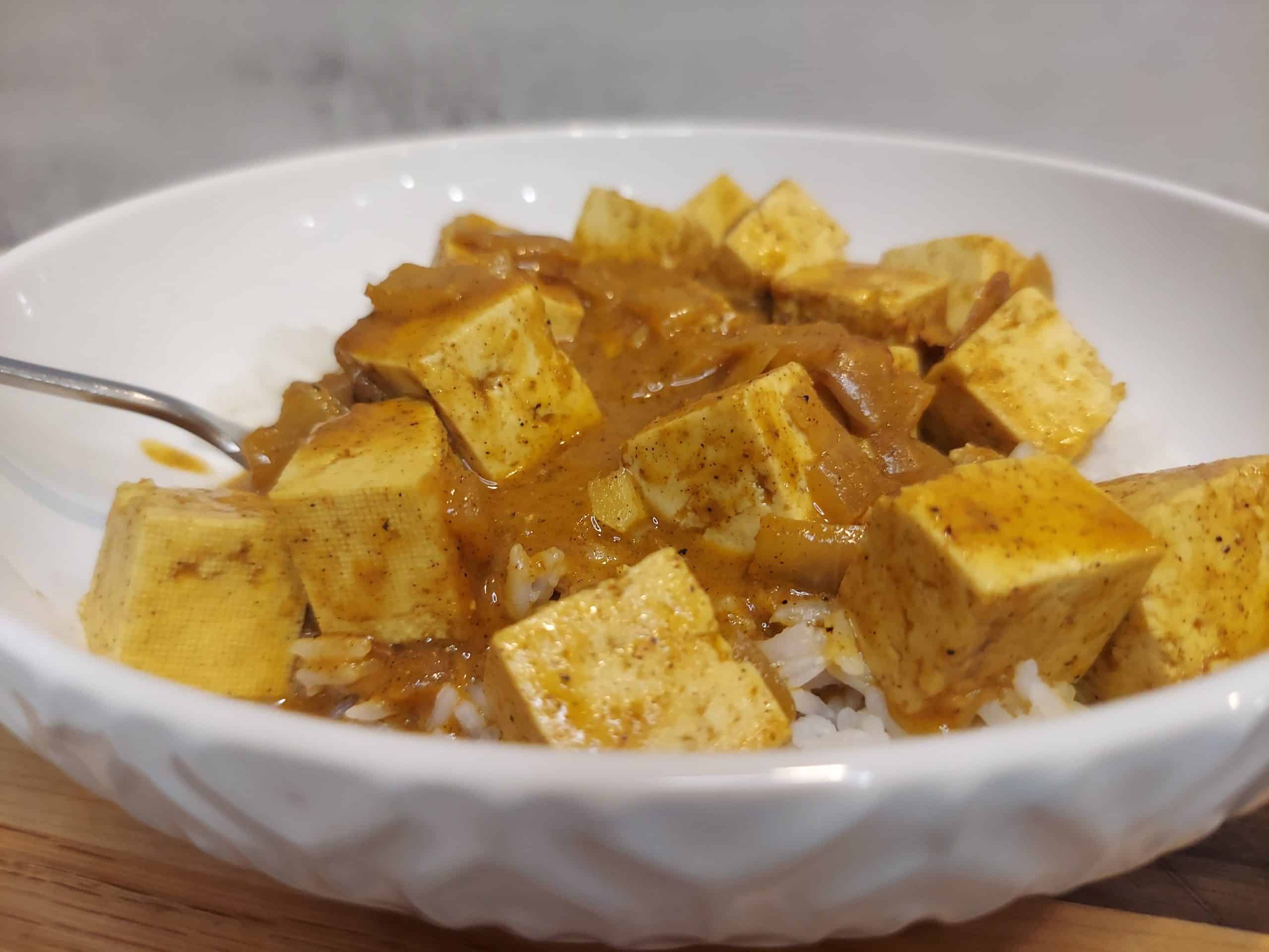 closeup of creamy vegan butter tofu curry with spices