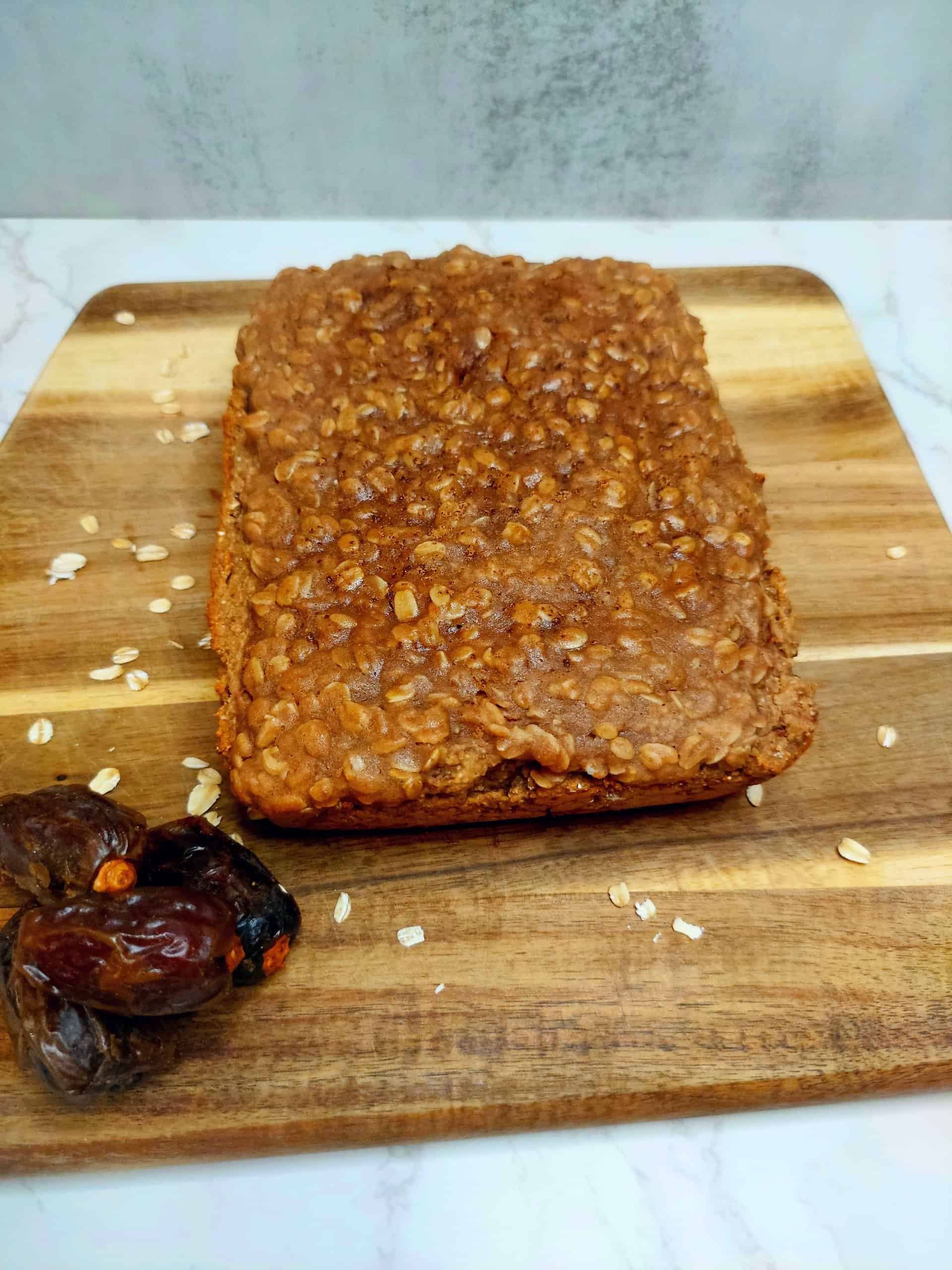 vegan protein coffee cake with oat streusel topping on a wooden cutting board