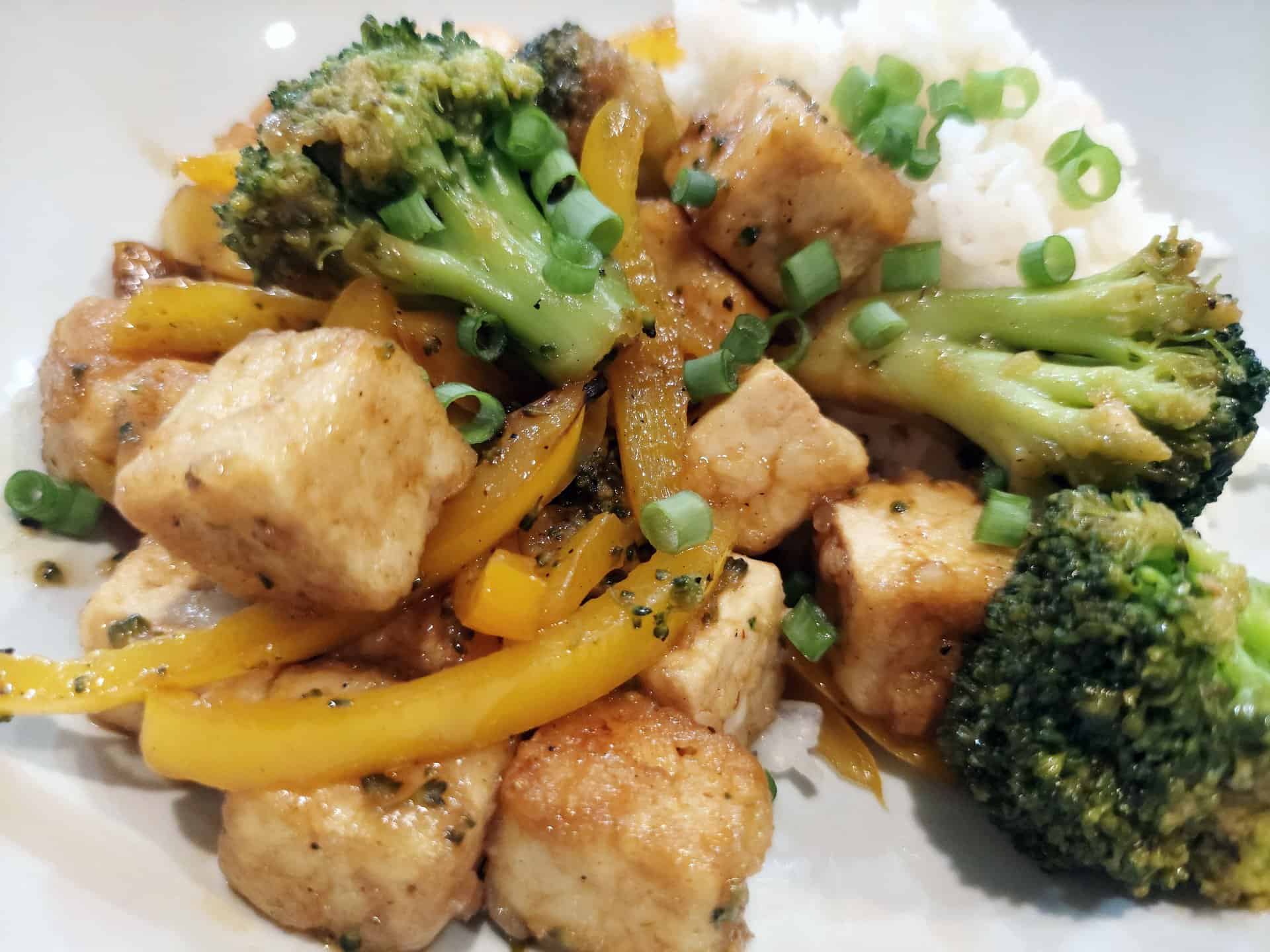 crispy tofu broccoli pepper stir fry with green onion garnish