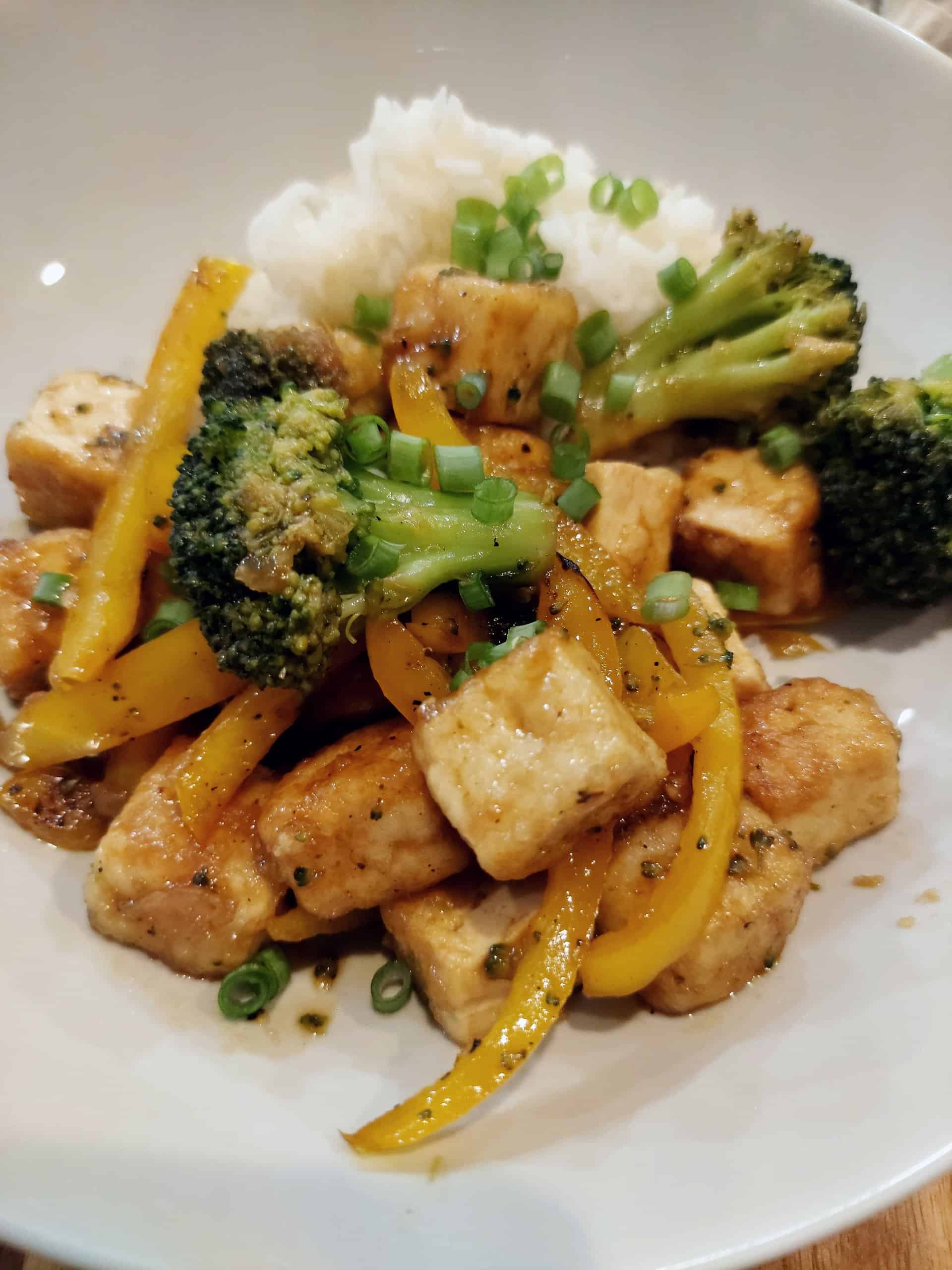 golden crispy tofu pieces with sauteed broccoli and bell pepper