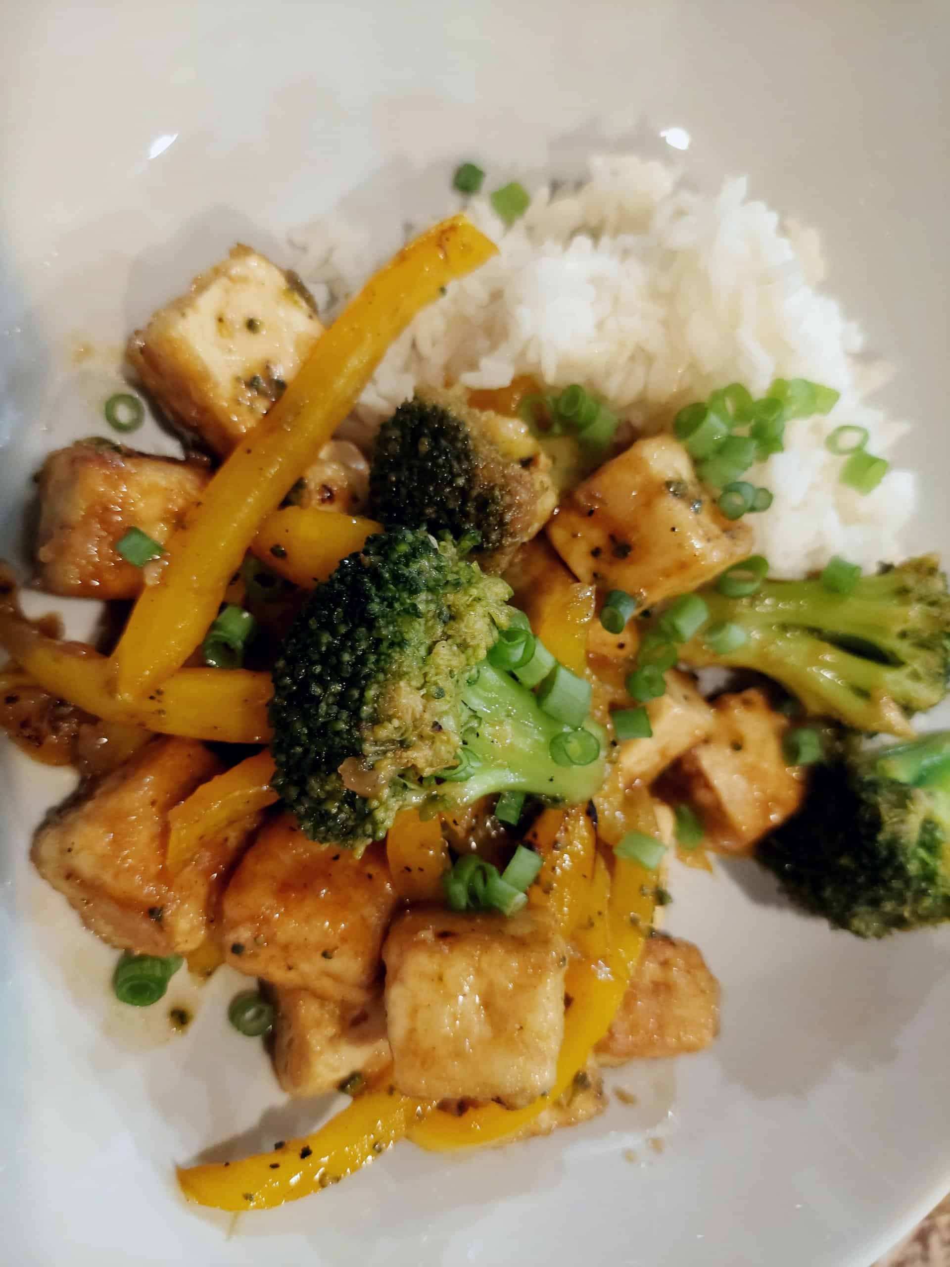 tofu broccoli stir fry bowl with yellow bell pepper and rice