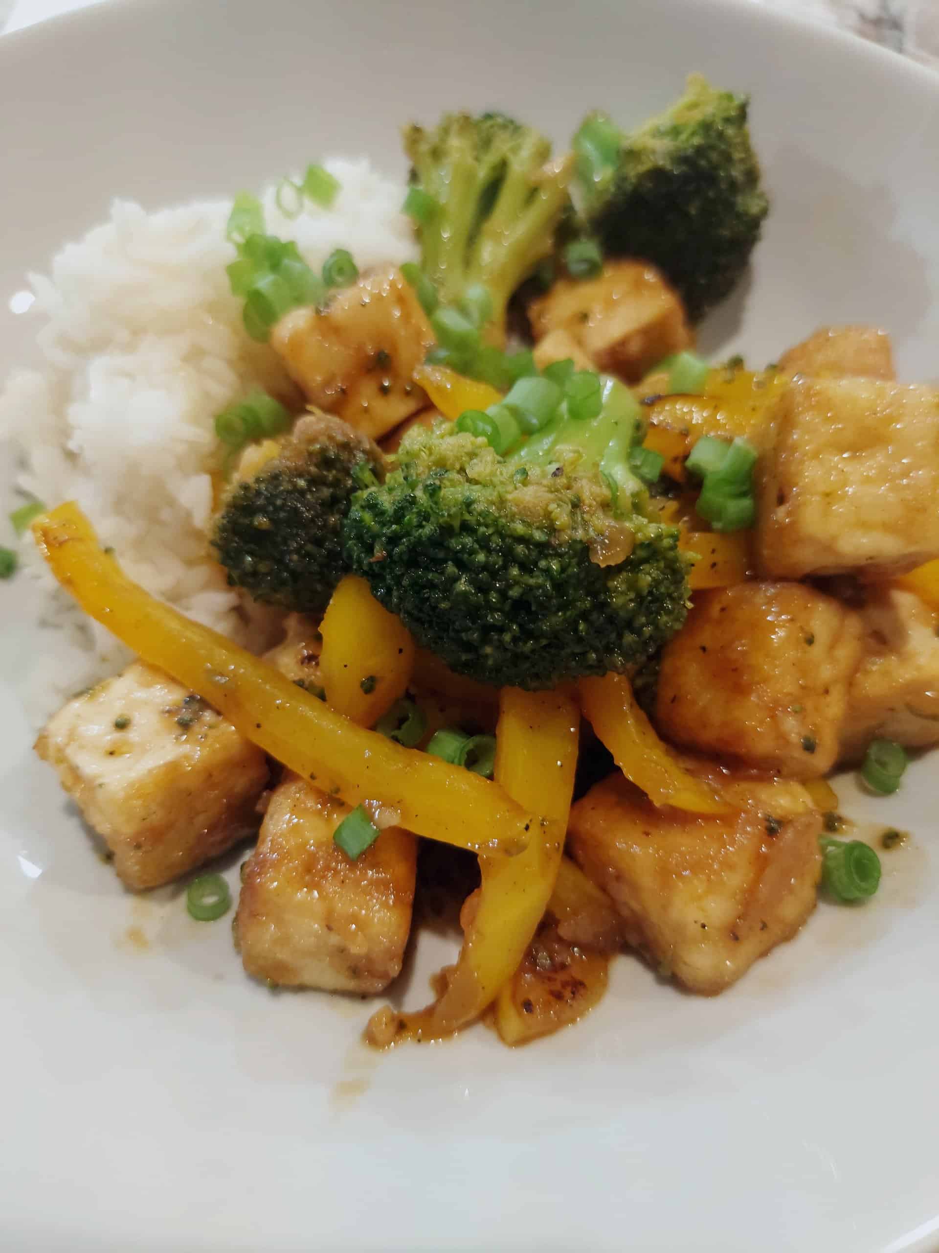 crispy tofu stir fry with broccoli and bell pepper served over white rice