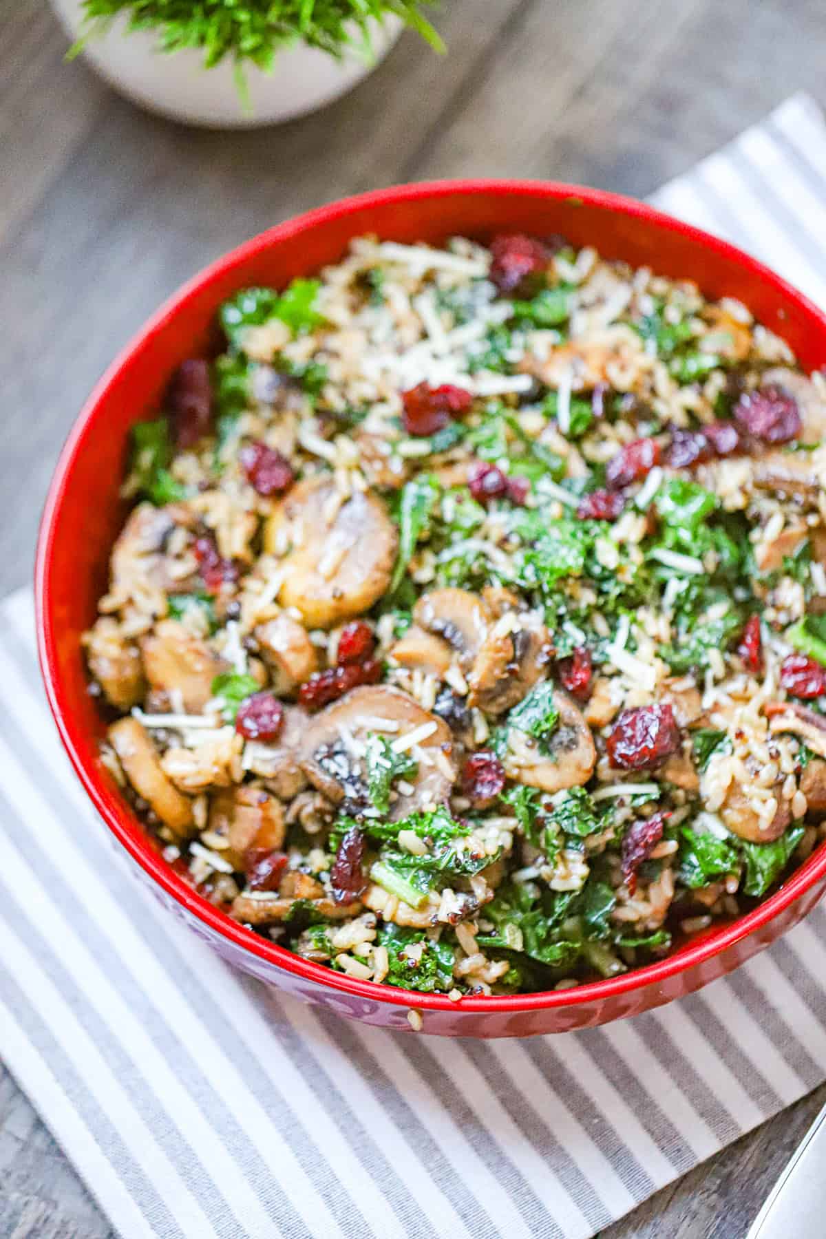 cremini mushrooms sautéing with kale in a large pot