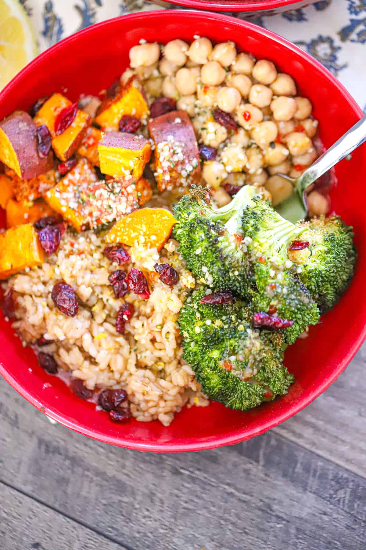 roasted sweet potato and broccoli with tahini dressing in a serving bowl