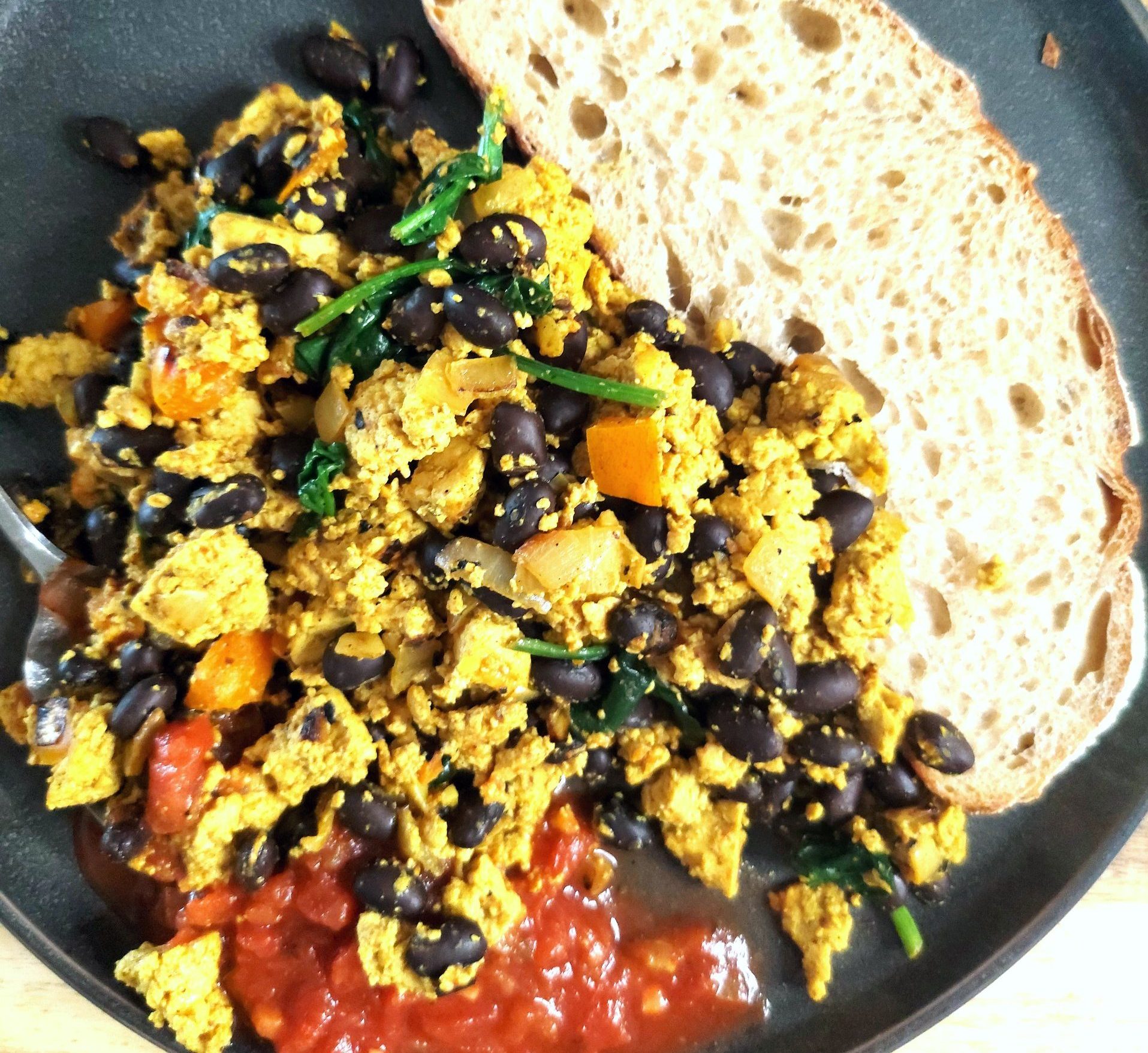 High-protein tofu scramble with black beans and spinach on a plate